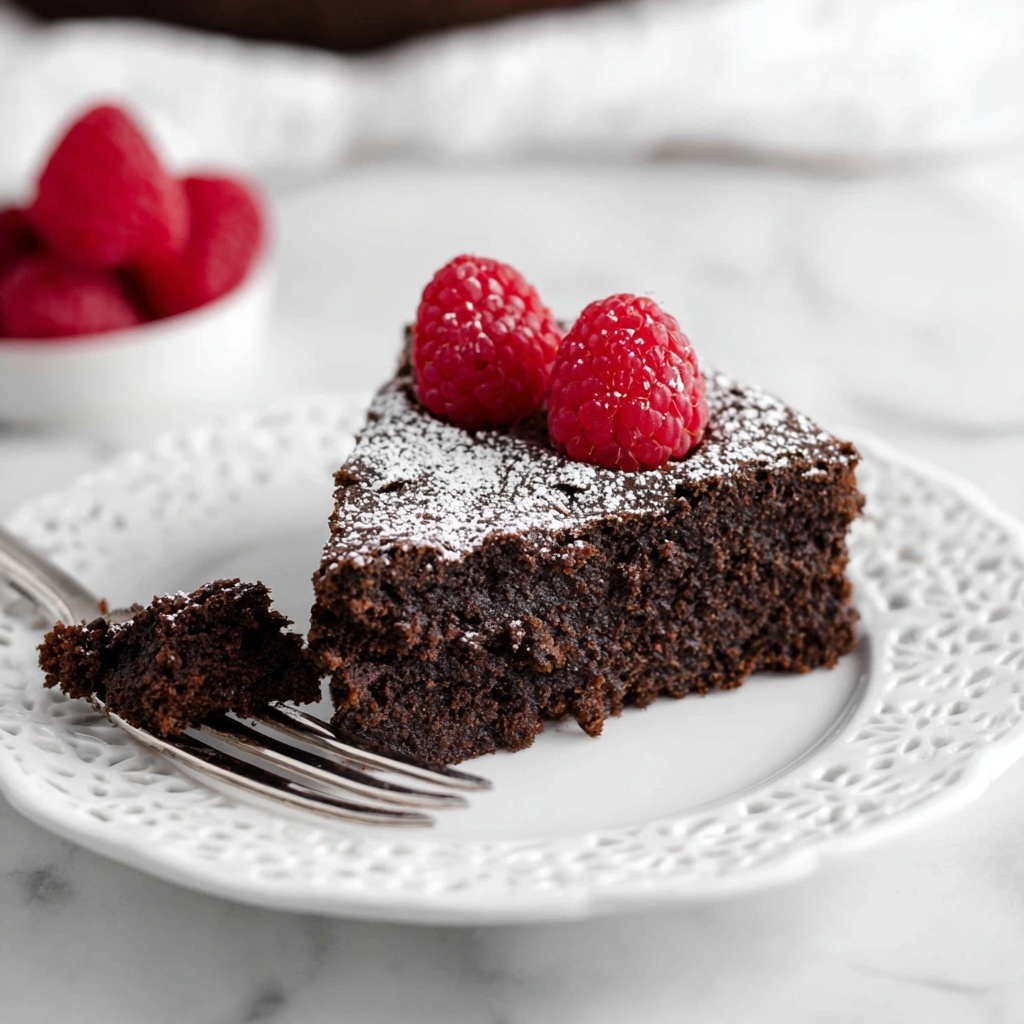 Flourless Chocolate Cake with Raspberries and Powdered Sugar Recipe - Recipe Image